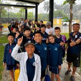 Swimming student competitors arrive at competition