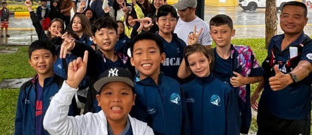 Swimming student competitors arrive at competition