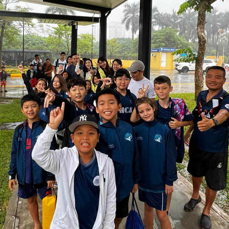 Swimming student competitors arrive at competition
