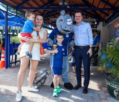An ISHCMC family posing with the school mascot