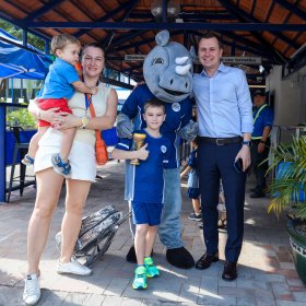An ISHCMC family posing with the school mascot