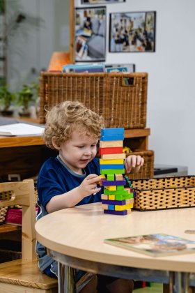 A young student playing with building blocks