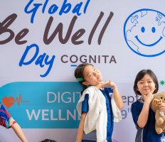 Students standing in front of a Cognita BeWell banner