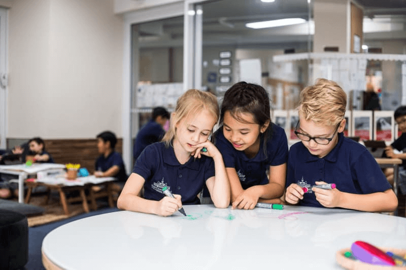 Pictured are three students studying