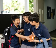 Three boys overcome with joy seeing each other