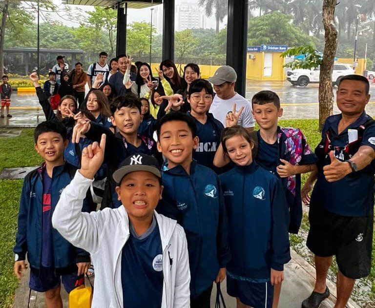 Swimming student competitors arrive at competition